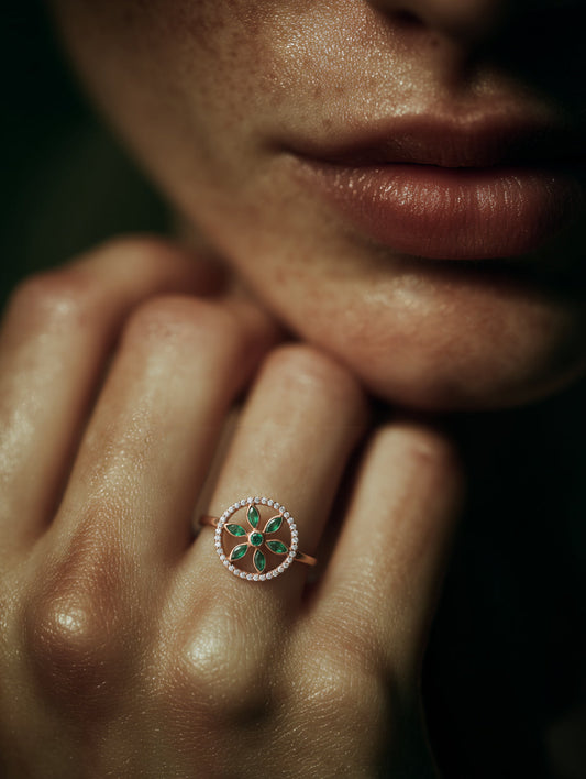 7LEAVES Unlock rose gold emerald and diamond ring worn on a hand