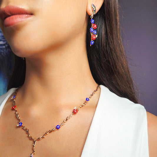 Close-up of a woman wearing a necklace and earrings with colorful beads.