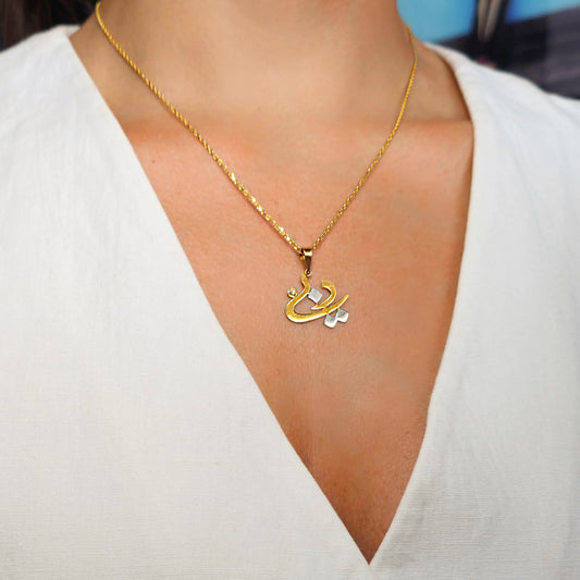 Gold necklace with a pendant on a white background