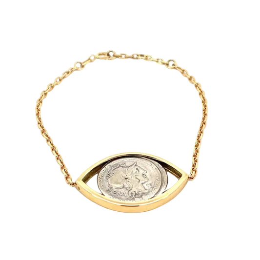 Gold bracelet with a coin design on a white background