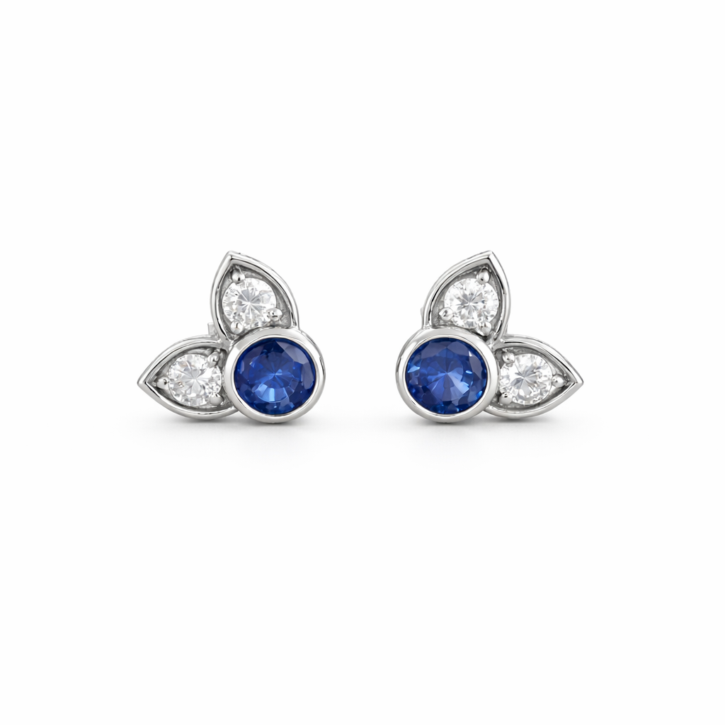 Pair of earrings with blue gemstones and diamond accents on a white background