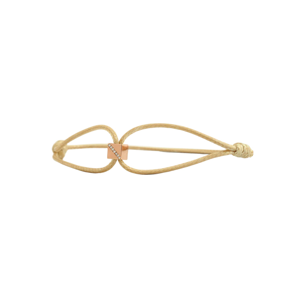 Beige hair tie with a gold clasp on a white background