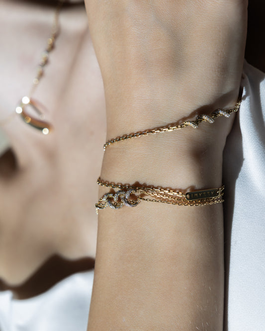 ALLAMI Spiral Bracelet by SAORA in yellow gold worn on a wrist, authentic J26 brand photoshoot
