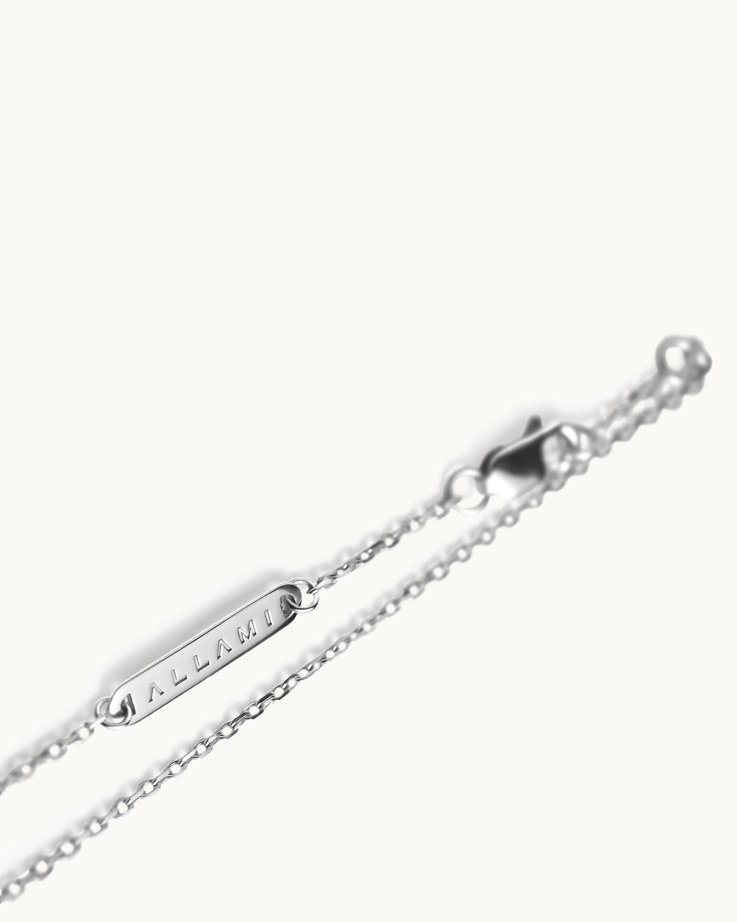 ALLAMI Spiral Necklace by SAORA in white gold, brand clasp detail