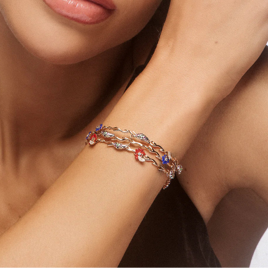 Close-up of a woman's wrist wearing a delicate bracelet with colorful stones.