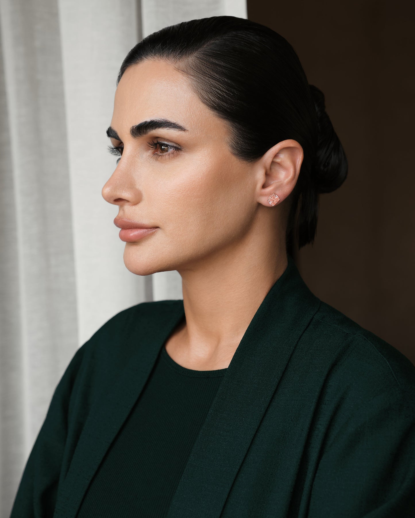 Model wearing Verbesa Atelier fancy pink cushion-cut lab-grown diamond stud earrings