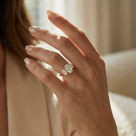 White Drop three stone oval diamond ring worn in an original lifestyle image