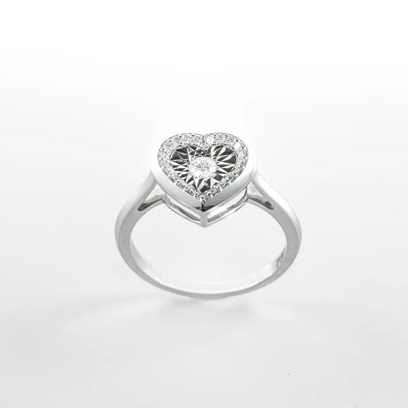 Heart-shaped diamond ring on a white background