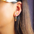 18k gold stud earrings with diamonds and white enamel, additional view
