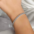 Caleums Yin and Yang white gold diamond bracelet worn on the wrist