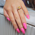 Caleums Sunlit Flare yellow sapphire and diamond ring worn on the hand