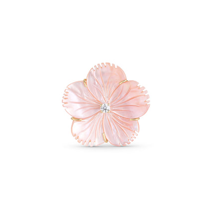 Pink flower-shaped brooch with a central gemstone on a white background