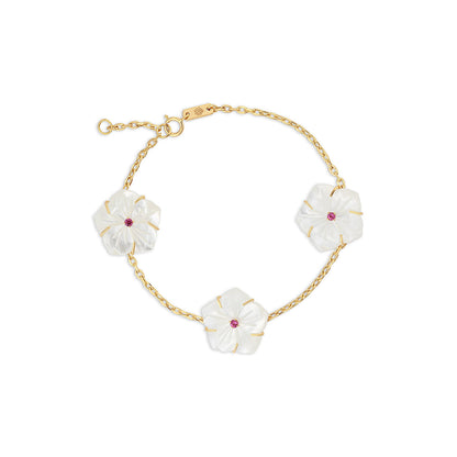 18k gold bracelet with three mother of pearl star flowers and rubies