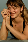 Model wearing the 7LEAVES Unlock rose gold emerald and diamond ring
