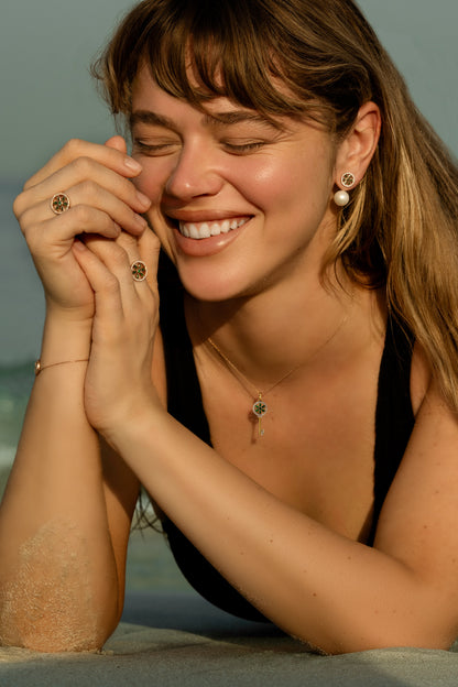 Model wearing the 7LEAVES Unlock rose gold emerald and diamond ring