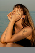 Model wearing the 7LEAVES Unlock rose gold emerald and diamond ring