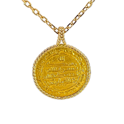 Gold necklace with a round pendant on a white background