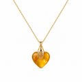 Gold necklace with a heart-shaped amber pendant on a white background