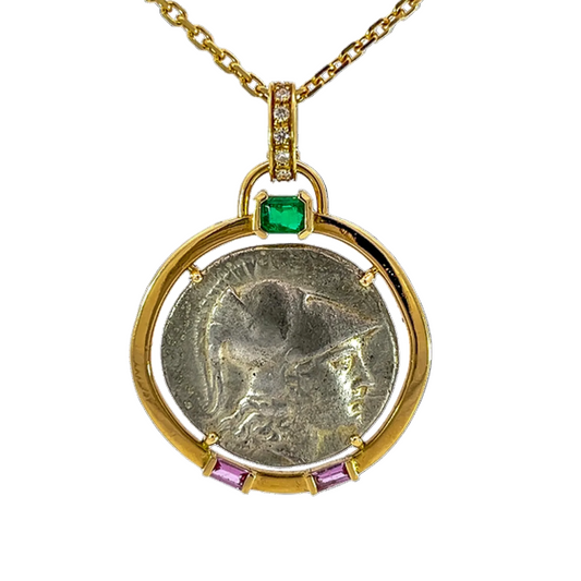 Gold pendant with emerald and pink gemstones featuring an ancient coin design on a white background