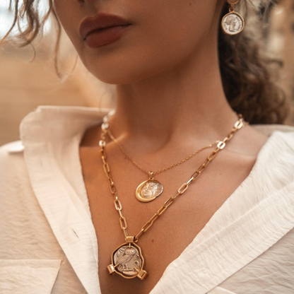 Close-up of a woman wearing gold necklaces and earrings 