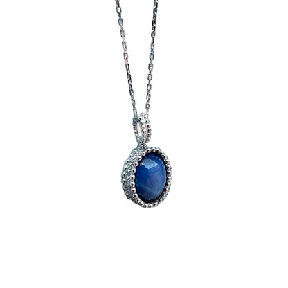 Blue gemstone necklace with gold chain on a white background