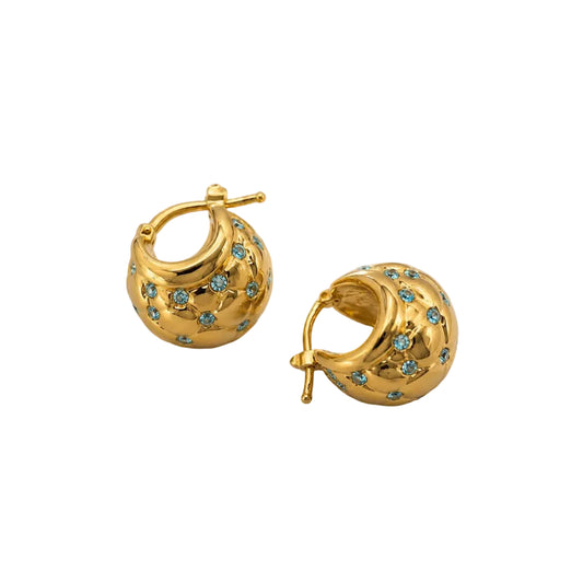 Gold hoop earrings with blue topaz 
stones