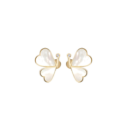 Butterfly-shaped earrings with gold frames and white centers on a white background