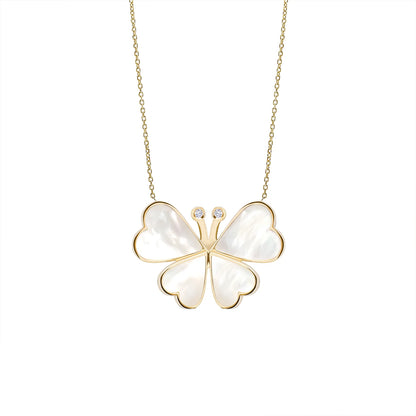 Butterfly-shaped pendant with gold outline and white center on a chain against a white background