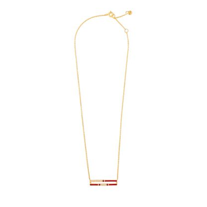 Gold necklace with a red and gold pendant on a white background