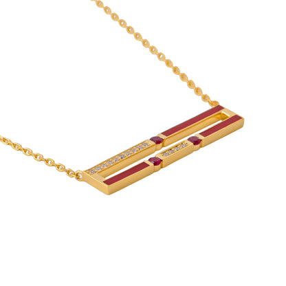 Gold necklace with red stones and small diamonds on a white background