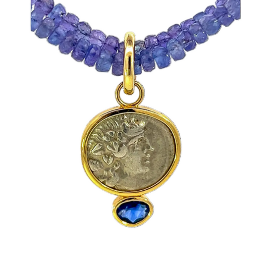 Necklace with blue beads and a gold pendant featuring a coin and blue stone on a white background