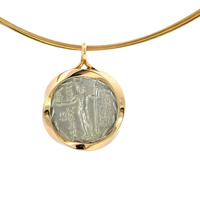 Gold necklace with a pendant featuring an ancient coin design on a white background