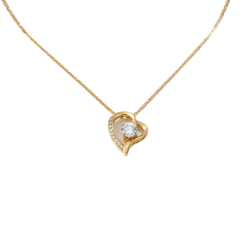 Gold necklace with a heart-shaped pendant on a white background
