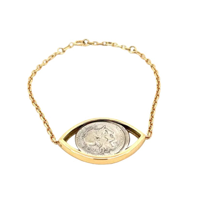 Gold bracelet with a coin design on a white background