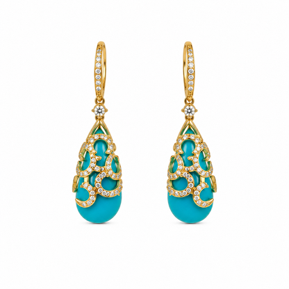 Pair of turquoise earrings with gold and diamond accents on a white background