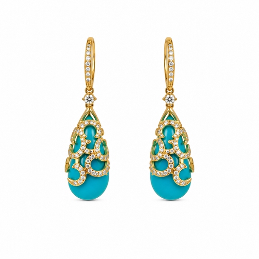 Pair of turquoise earrings with gold and diamond accents on a white background
