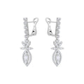Pair of white gold earrings with diamond-like stones on a white background