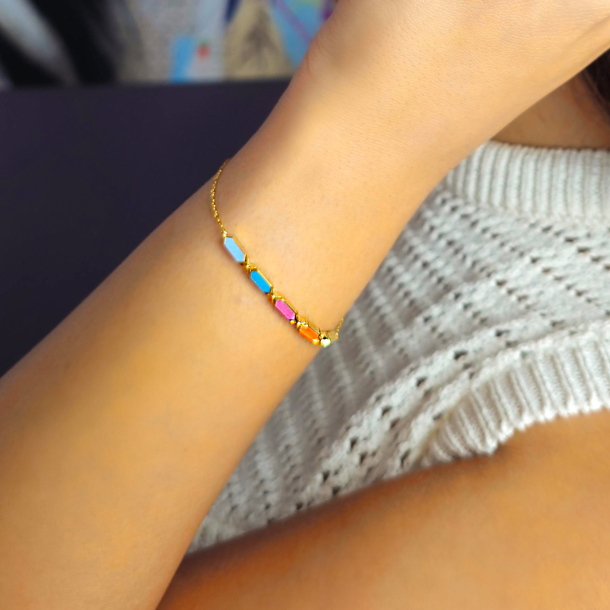 Multicolored beaded bracelet on a wrist with a blurred background