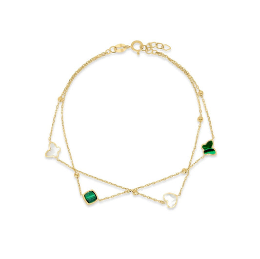 Gold bracelet with green gemstones on a white background