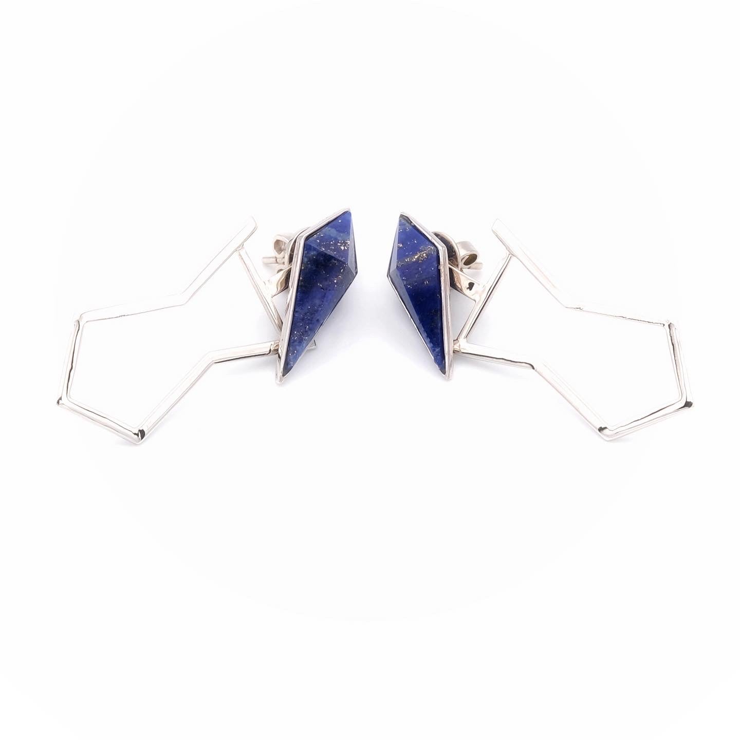 Pair of geometric gold earrings with blue triangular stones on a white background