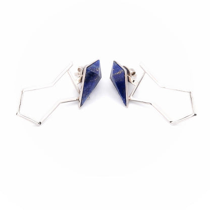 Pair of geometric gold earrings with blue triangular stones on a white background