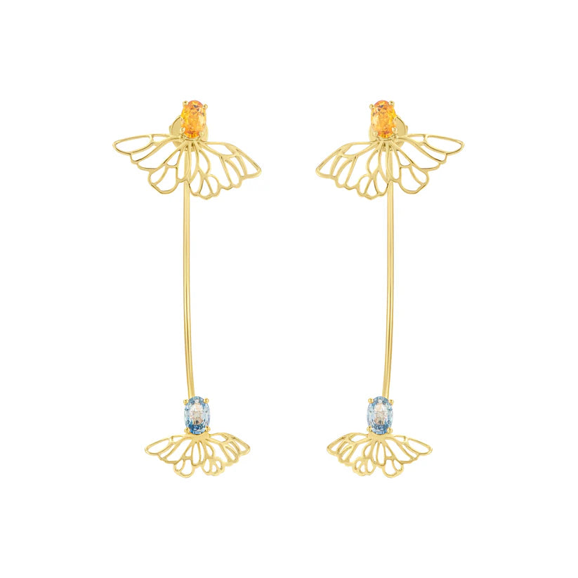 Gold earrings with floral designs and gemstones on a white background