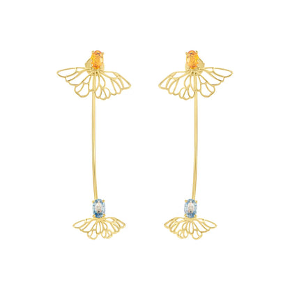 Gold earrings with floral designs and gemstones on a white background