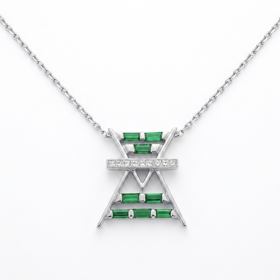 Gold necklace with a triangular pendant featuring green gemstones on a white background