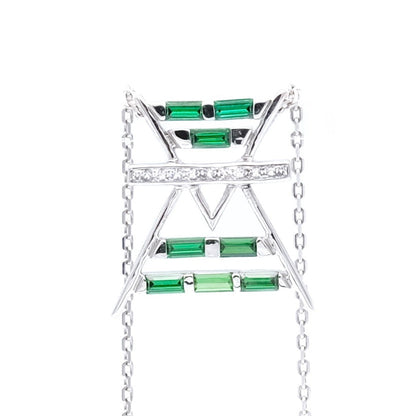 Jewelry with green gemstones and a gold chain on a white background
