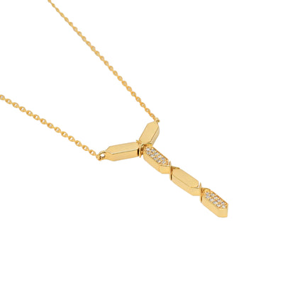 Gold necklace with geometric pendant on a white background