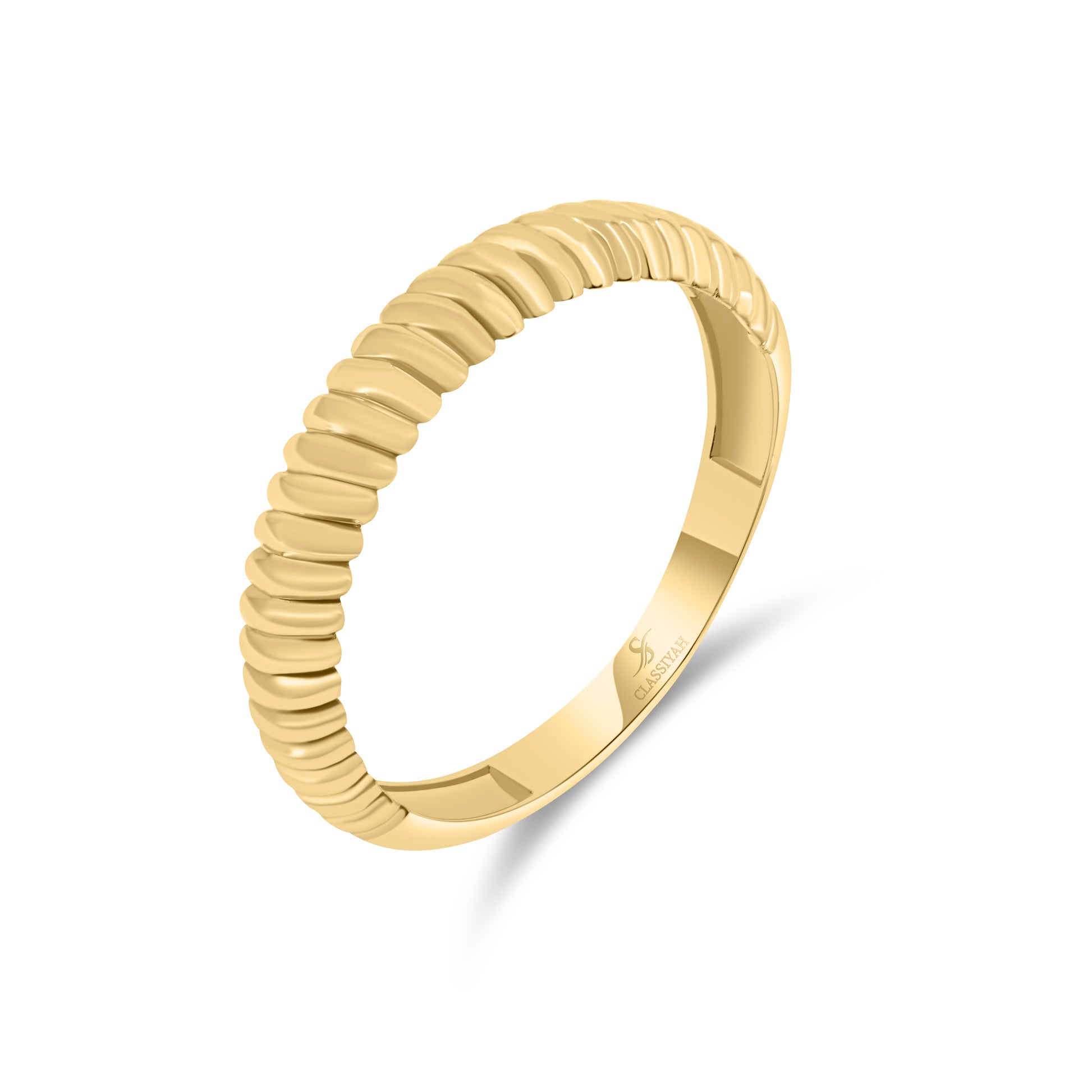 Gold ring with a textured band on a white background