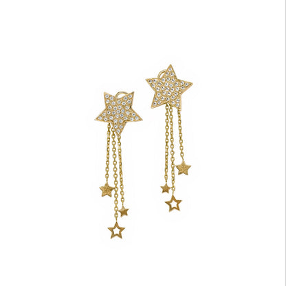 Gold star earrings with chain drops on a white background