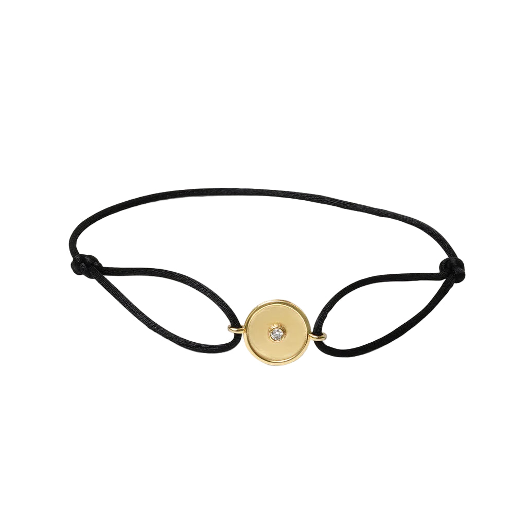 Black bracelet with a gold clasp on a white background