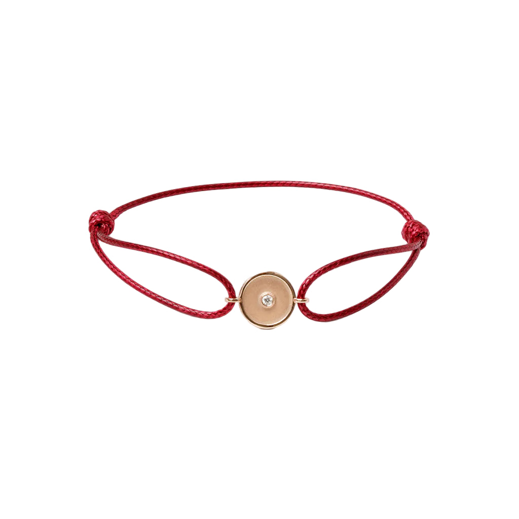 Red bracelet with a gold clasp on a white background